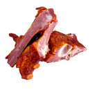 Delumani smoked pork tongue, homemade cured meat from Delumani, showcasing the smoked and sliced meat product.