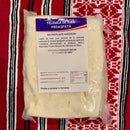 Fresh Sibiu sheep milk Telemea cheese from Asociatia Producatorilor de Telemea de Sibiu, showing creamy, crumbly cheese in a rustic setting.